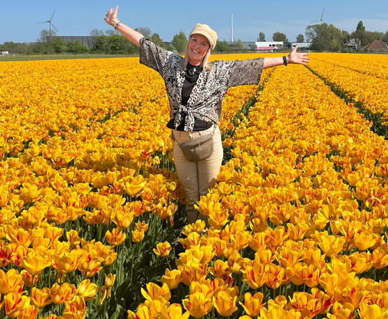 Maaike your local tourguide  wearing Dutch wooden shoes. Windmill, Tulips, Cheese, Zaanse Schans, Keukenhof, Volendam, Marken, Alkmaar.