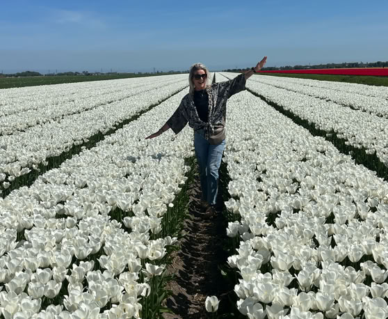 Maaike your local tourguide  wearing Dutch wooden shoes. Windmill, Tulips, Cheese, Zaanse Schans, Keukenhof, Volendam, Marken, Alkmaar.