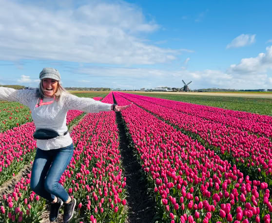 Maaike your local tourguide  wearing Dutch wooden shoes. Windmill, Tulips, Cheese, Zaanse Schans, Keukenhof, Volendam, Marken, Alkmaar.