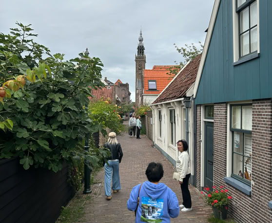 Maaike your local tourguide  wearing Dutch wooden shoes. Windmill, Tulips, Cheese, Zaanse Schans, Keukenhof, Volendam, Marken, Alkmaar.