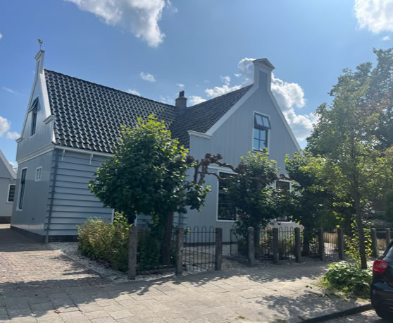 Maaike your local tourguide  wearing Dutch wooden shoes. Windmill, Tulips, Cheese, Zaanse Schans, Keukenhof, Volendam, Marken, Alkmaar.