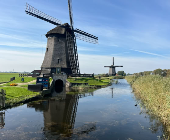 Maaike your local tourguide  wearing Dutch wooden shoes. Windmill, Tulips, Cheese, Zaanse Schans, Keukenhof, Volendam, Marken, Alkmaar.