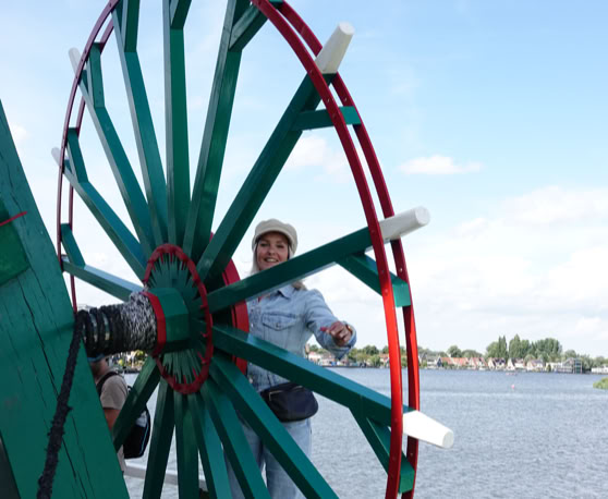 Maaike your local tourguide  wearing Dutch wooden shoes. Windmill, Tulips, Cheese, Zaanse Schans, Keukenhof, Volendam, Marken, Alkmaar.