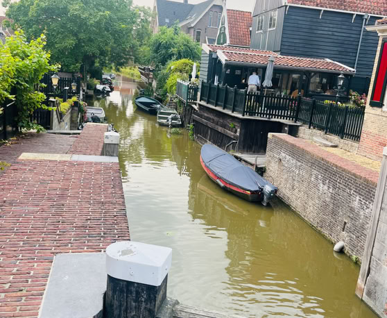 Maaike your local tourguide  wearing Dutch wooden shoes. Windmill, Tulips, Cheese, Zaanse Schans, Keukenhof, Volendam, Marken, Alkmaar.