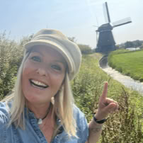 Maaike your local tourguide  wearing Dutch wooden shoes. Windmill, Tulips, Cheese, Zaanse Schans, Keukenhof, Volendam, Marken, Alkmaar.