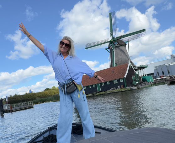 Maaike your local tourguide  wearing Dutch wooden shoes. Windmill, Tulips, Cheese, Zaanse Schans, Keukenhof, Volendam, Marken, Alkmaar.