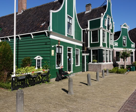 Maaike your local tourguide  wearing Dutch wooden shoes. Windmill, Tulips, Cheese, Zaanse Schans, Keukenhof, Volendam, Marken, Alkmaar.