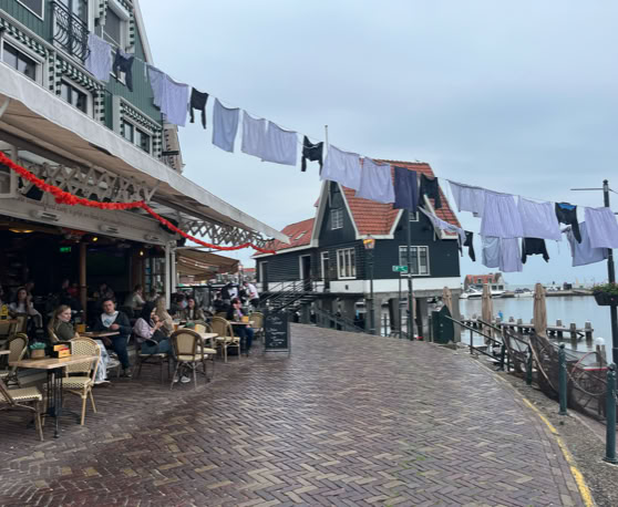Maaike your local tourguide  wearing Dutch wooden shoes. Windmill, Tulips, Cheese, Zaanse Schans, Keukenhof, Volendam, Marken, Alkmaar.